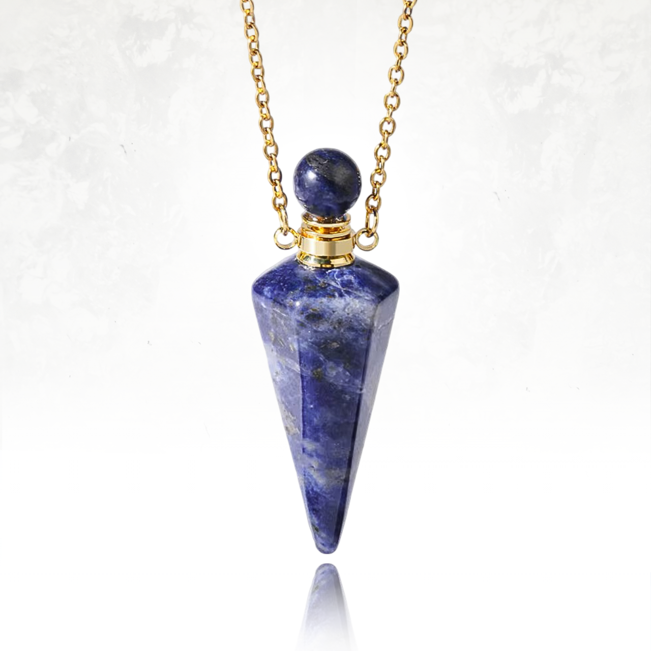 Pendentif artisanal en cristal poli de sodalite, fiole précieuse pour parfums.