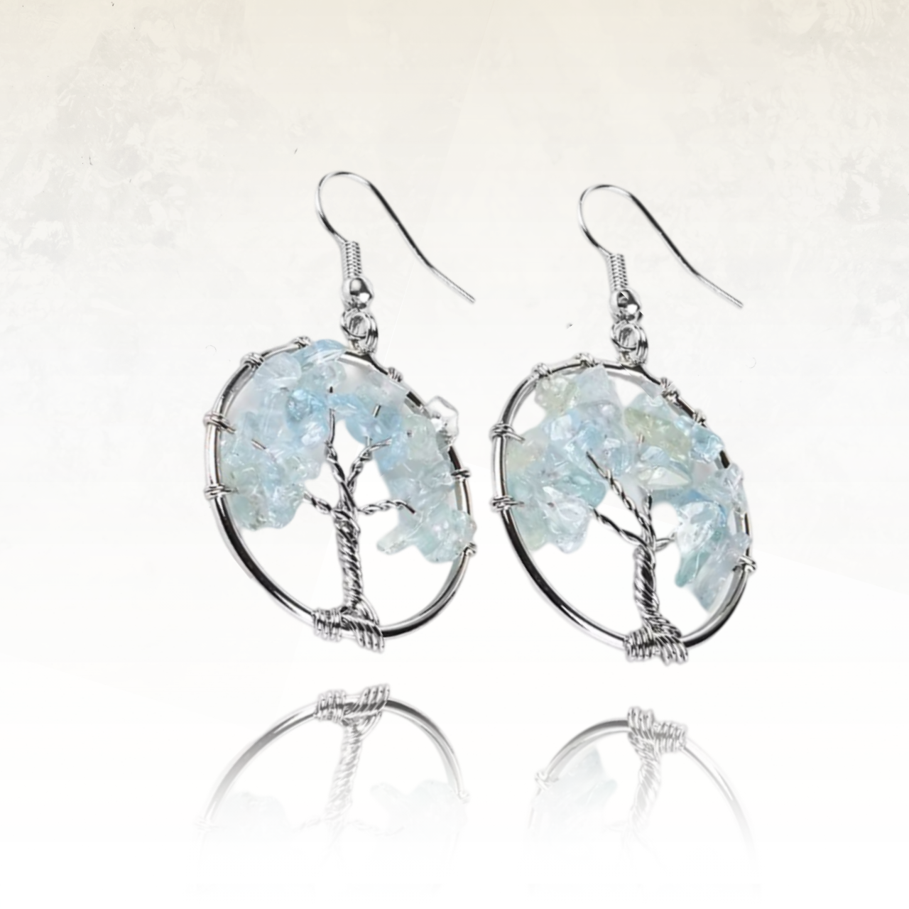 boucles d'oreilles fabrqiuéd avec des files métalliques tressés en forme d'arbre et des pierres naturelles formant les fruits de l'arbre