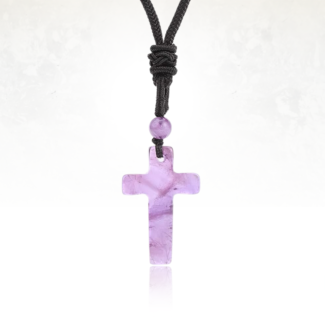Talisman en croix sculpté en amethyste, pierre de protection.