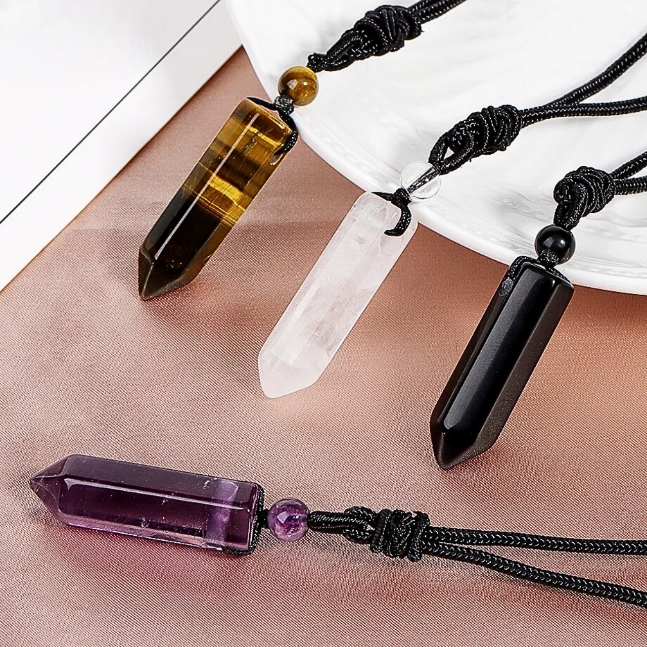 Pendentifs PRODIGE en pierres naturelles montés sur un collier en cordon noir ajustable.
