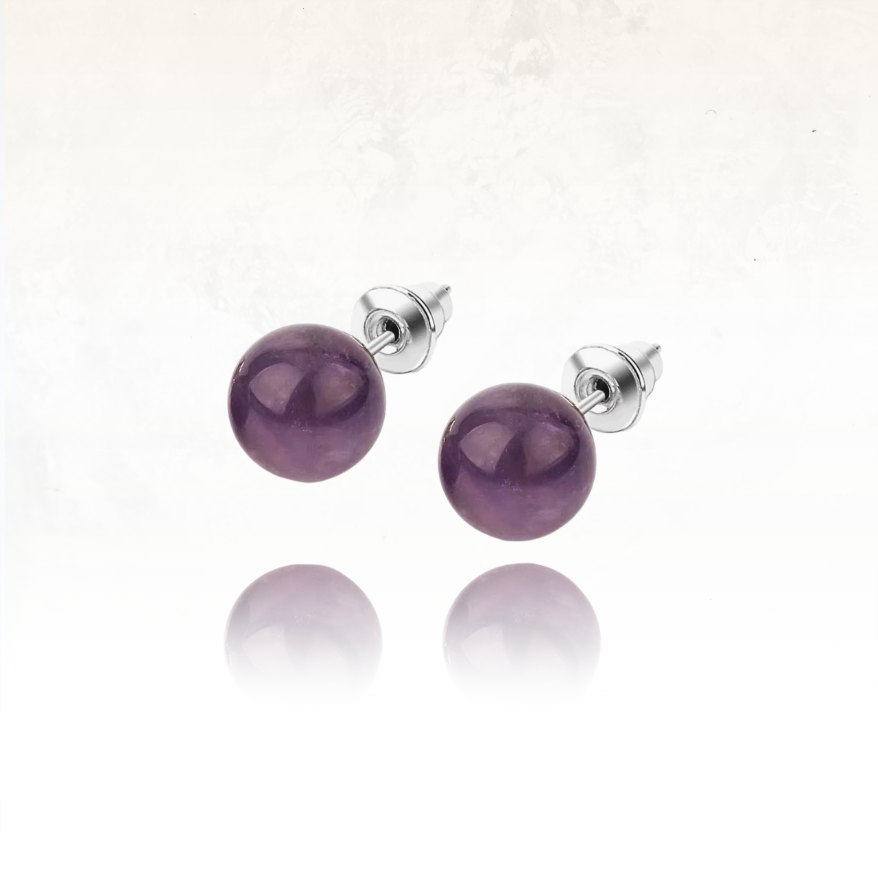 Paire de boucles d'oreilles en pierre naturelle violette avec fermoir poussette.